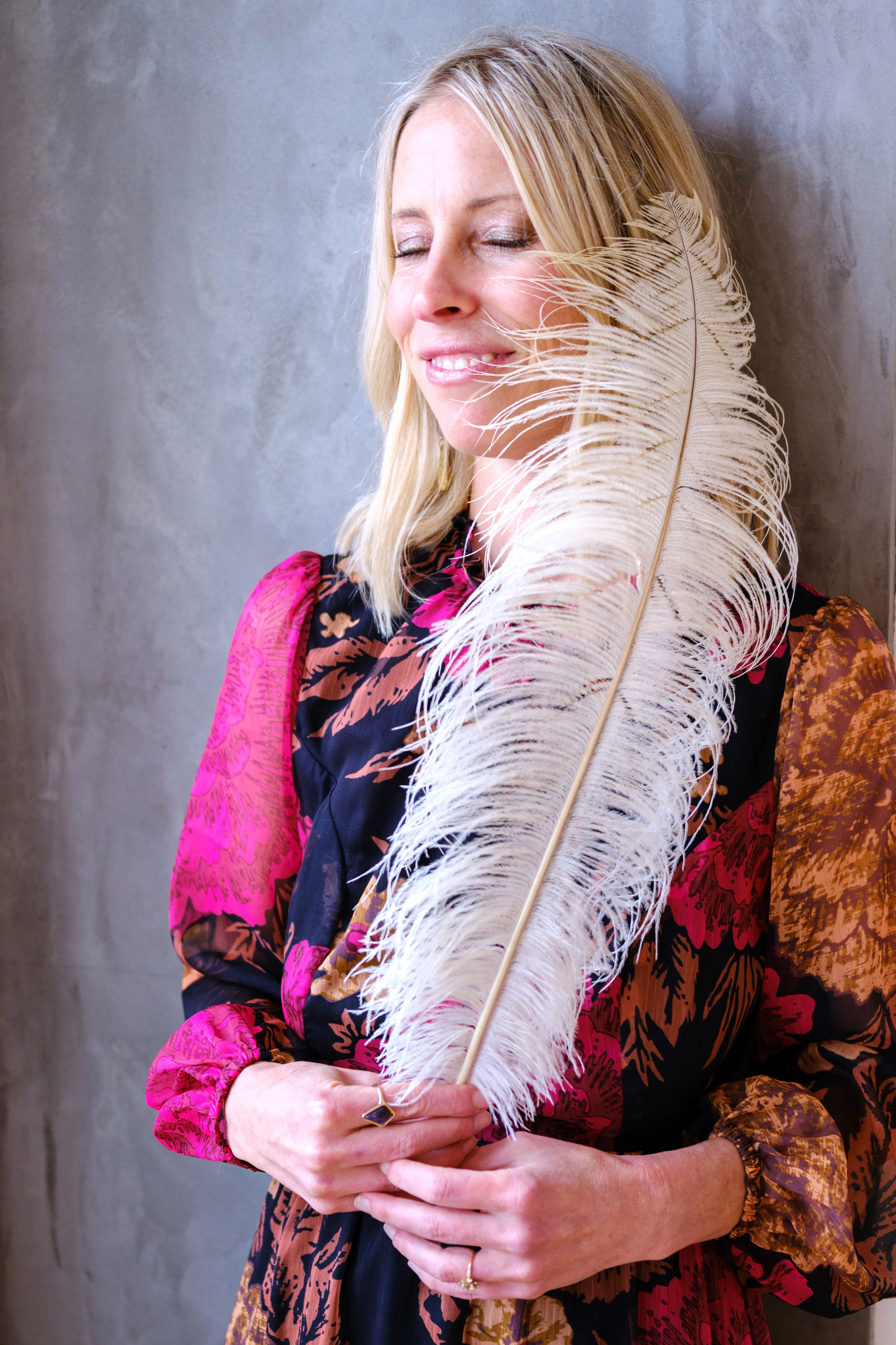 Kelci Heart holding a white feather