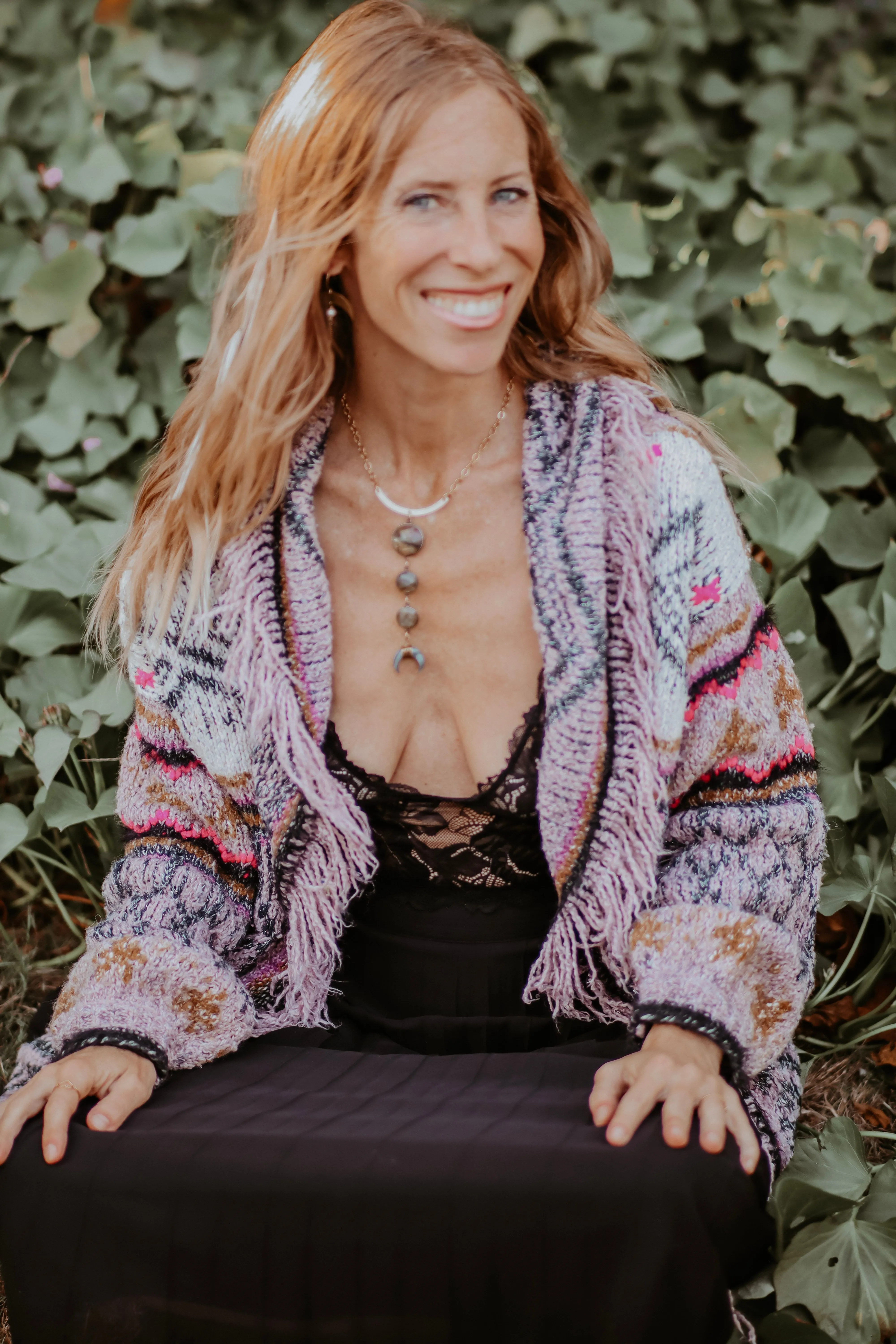 Kelci Heart wearing a purple cardigan